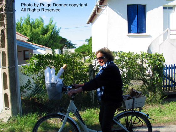 Ile de Noirmoutier - Lady on bicycle with baguette. Photo by Paige Donner copyright 2014 all rights reserved. 